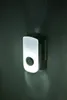 A night light with a camera lens is plugged into a wall. Produktbild-Vorschau