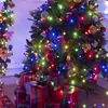 Christmas trees decorated with colorful lights and ornaments, with wrapped gifts at the base. Voir les images du produit