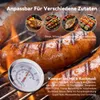 Close-up of sausages and other food items on a grill, with a thermometer in the foreground. Anteprima dell’immagine prodotto