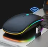 A wireless mouse with RGB lighting is placed on a laptop keyboard. Produktbild-Vorschau