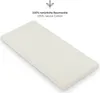 A close-up, angled view of a light-colored baby crib sheet on a white background, with text and a leaf icon in the upper right corner. Produktbild-Vorschau
