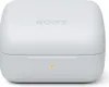 A white charging case for wireless earbuds, with the Sony logo embossed on the lid and a small orange indicator light on the front. Produktbild-Vorschau