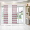 A room with a large sliding glass door covered by panel blinds. The blinds have a striped pattern in light gray and raspberry colors. The room has white flooring and a white console table with a mirror above it. Anteprima dell’immagine prodotto