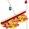 A broom sweeping fallen leaves. Produktbild-Vorschau