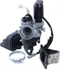 A collection of motorcycle carburetor parts, including the carburetor itself, an intake manifold, a reed valve assembly, and a hose clamp, arranged against a white background. Produktbild-Vorschau