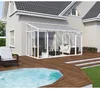 A conservatory attached to a house, with a deck and a pool. Podgląd zdjęcia produktu