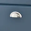 A close-up shot of a silver drawer pull on a blue cabinet. Náhled obrázku produktu