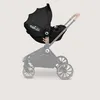 A black baby car seat is attached to a stroller frame. Produktbild-Vorschau
