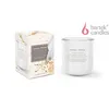 A white scented candle in a glass jar and its packaging are displayed on a white background. Voir les images du produit