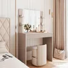 A vanity table set in a bedroom with soft lighting and decor. Produktbild-Vorschau