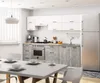 A modern kitchen with white cabinets, a stainless steel refrigerator and stove, and gray cabinets. Náhled obrázku produktu