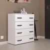 A white dresser with black handles stands in a room with a brown wall and a dark door. Produktbild-Vorschau