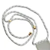 A white and gray cord with gold accents, attached to a clear phone case. Náhled obrázku produktu
