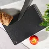 A cutting board with a knife, bread, and an apple on a wooden surface. Náhľad obrázku produktu
