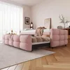 A pink upholstered daybed with an extended trundle bed in a bedroom setting. Produktbild-Vorschau