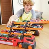 A young boy is playing with a Hot Wheels Mega-Truck filled with toy cars. Náhled obrázku produktu