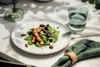 A table setting with a salad and a glass of water. Produktbild-Vorschau
