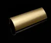 A close-up studio shot of a single gold-colored door handle on a black reflective surface. Produktbild-Vorschau
