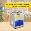 A digital ultrasonic cleaner is displayed on a wooden surface, with a blurred background of a store or office setting. Voir les images du produit