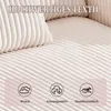 A close-up view of a beige corduroy sofa, highlighting its texture and featuring three icons with descriptive text below them. Produktbild-Vorschau
