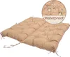 A taupe-colored, tufted cushion for a bench or seat, shown from a diagonal angle on a white background. A circular inset highlights water droplets on the fabric, with the word 'Waterproof' printed below. Náhled obrázku produktu