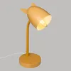 A yellow desk lamp with cat-ear accents, shown against a plain gray background. Náhled obrázku produktu