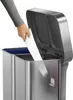A hand is shown placing an item into a dual-compartment trash can. Podgląd zdjęcia produktu