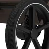 A close-up of a stroller wheel with suspension. Náhled obrázku produktu