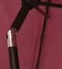 A close-up view of the internal structure of a bordeaux red umbrella, showing the metal mast and fabric. Produktbild-Vorschau