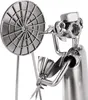 A close-up of a metal figurine of a dart player aiming at a dartboard. Náhled obrázku produktu