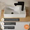 A white rectangular sink with a black faucet on a wooden surface. Produktbild-Vorschau