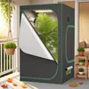 A grow tent is set up on a balcony with plants inside and outside, suggesting an indoor gardening setup. Voir les images du produit