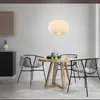 A dining table with chairs and a pendant light in a modern room. Produktbild-Vorschau