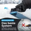 A hand wearing a glove is using an ice scraper to remove snow and ice from a car windshield. Produktbild-Vorschau