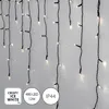 A close-up of LED icicle lights hanging against a light gray wall. Podgląd zdjęcia produktu