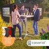 People are socializing around a high table in a garden setting with a tent in the background. Produktbild-Vorschau