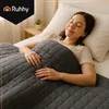 A woman sleeping peacefully in bed, covered by a weighted blanket. Produktbild-Vorschau