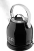 A black KitchenAid electric kettle with steam rising from the spout, placed on its black base. Produktbild-Vorschau