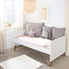 A child's bedroom with a white daybed, pillows, and a rug. Produktbild-Vorschau