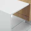 A close-up view of a modern furniture piece, likely a TV stand or cabinet, showing its white and wood grain finish with a glass shelf. Voir les images du produit