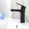 A black faucet in a bathroom sink with water running. Náhľad obrázku produktu