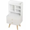 A white bedside table with two drawers and a small bookshelf on top, shown against a white background. Podgląd zdjęcia produktu
