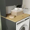 A laundry room with a washing machine and a cabinet. Anteprima dell’immagine prodotto
