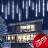 A modern house decorated with white icicle lights for the holidays. Produktbild-Vorschau