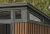 Close-up view of the upper section of a garden shed, showing windows and wood-like siding. Náhľad obrázku produktu