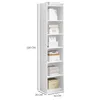 A tall, narrow white bookshelf filled with various items. Podgląd zdjęcia produktu