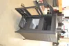 A dark gray wood-burning stove with its doors open, revealing the interior compartments. The stove is placed on a light gray floor. Voir les images du produit