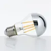 A single LED light bulb with a mirrored top half, lying on its side on a white surface. Produktbild-Vorschau
