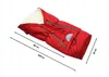 A red winter footmuff with cream lining, shown on a white background with measurement lines and text. Produktbild-Vorschau