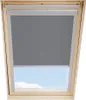 A grey blackout roller blind installed in a wooden framed attic window, with a view of the sky and clouds visible through the lower portion of the window. Produktbild-Vorschau